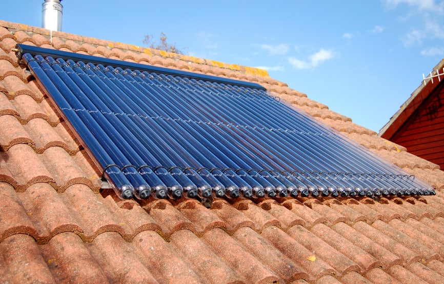 Image showing evacuated-tube type of solar thermal panel on a rooftop.