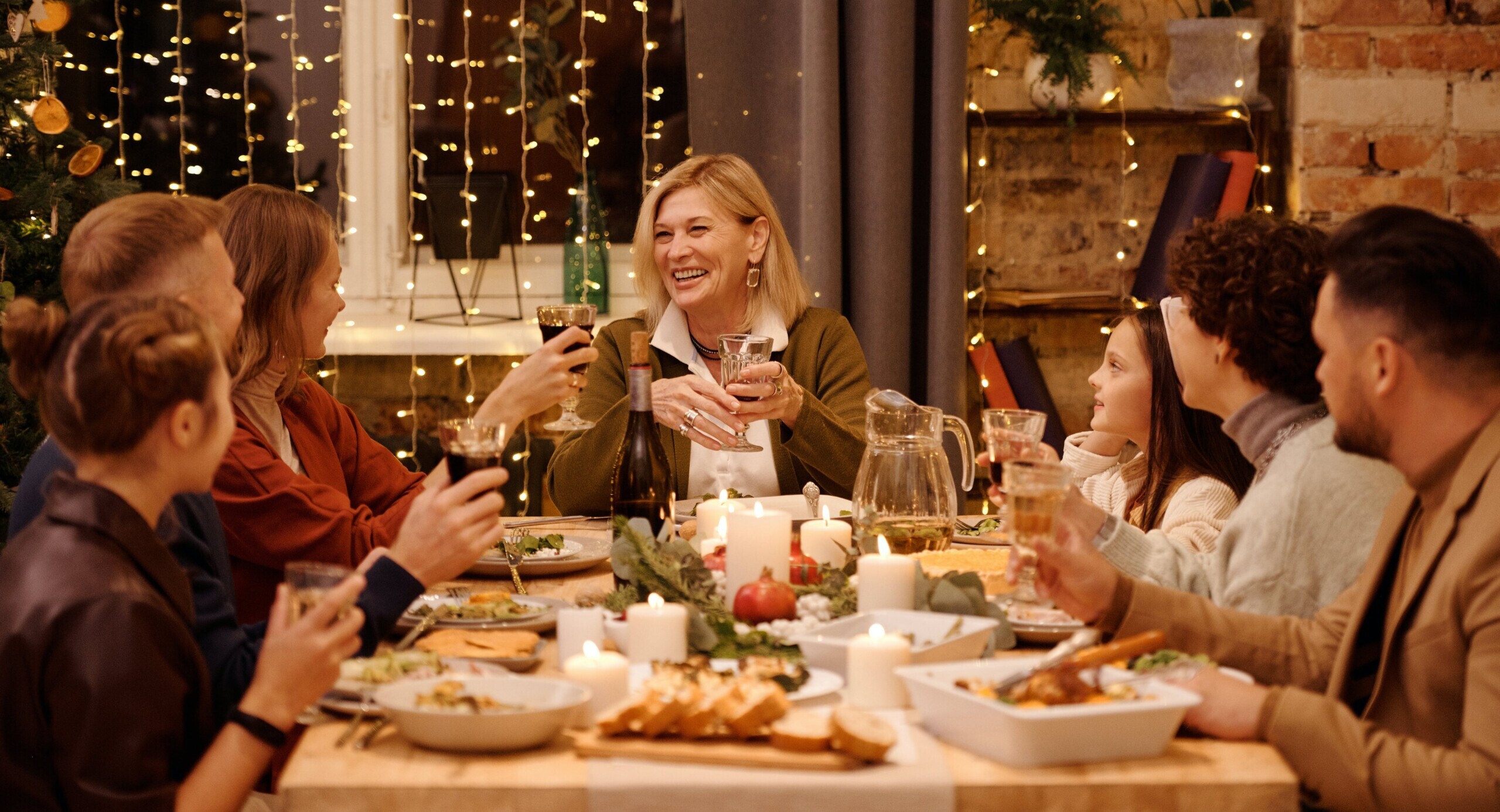 A family sitting around a festive dinner table.