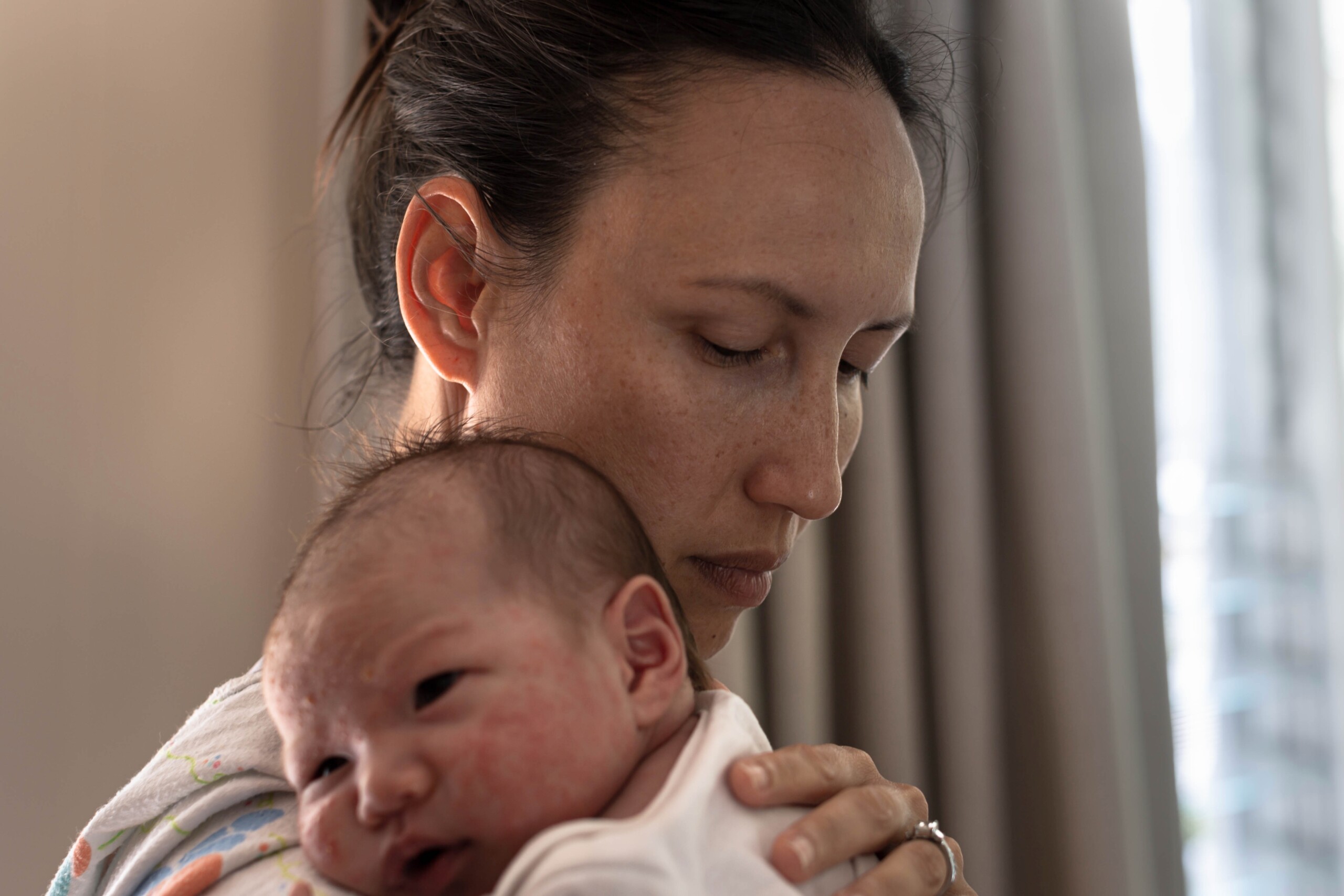 A woman holds her baby.