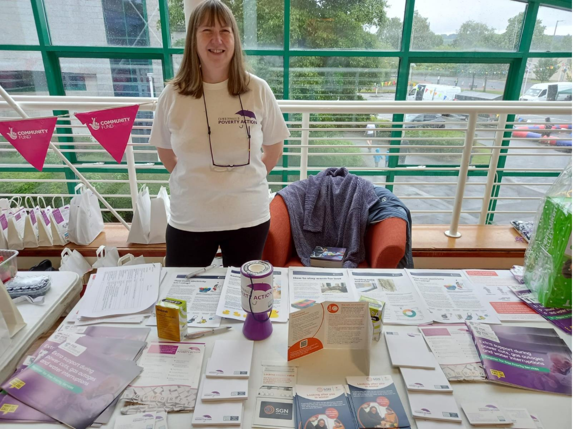 A woman standing at an advice booth for cumbernauld gala day